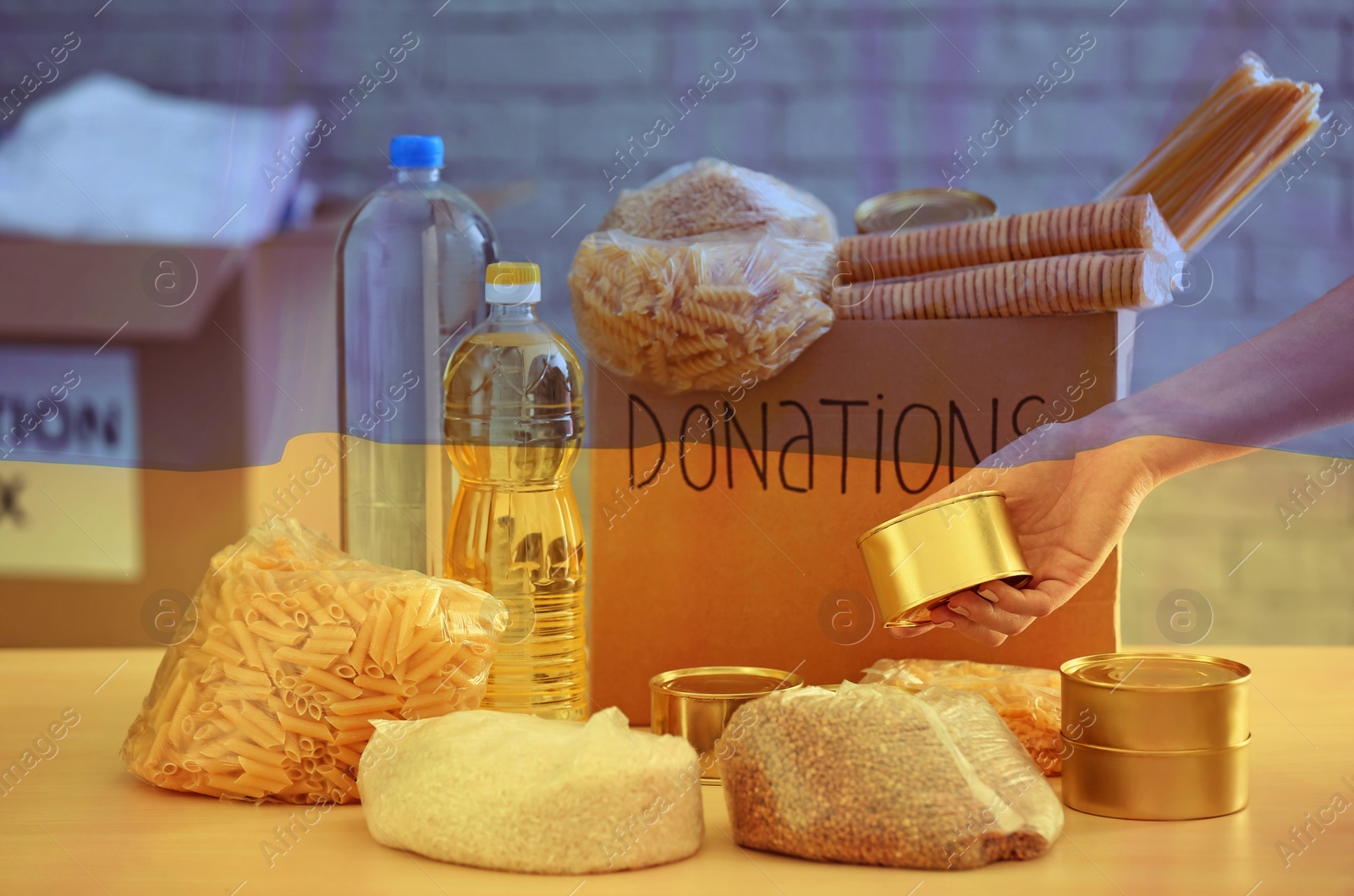 Image of Double exposure of volunteer collecting food for donation box and Ukrainian flag. Help during war