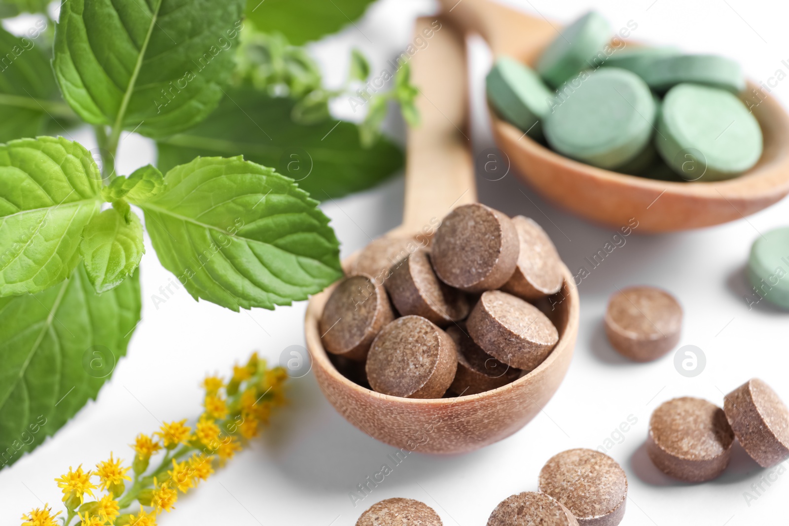 Photo of Different pills and herbs on white background, closeup. Dietary supplements