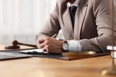 Photo of Lawyer working at table in office, closeup