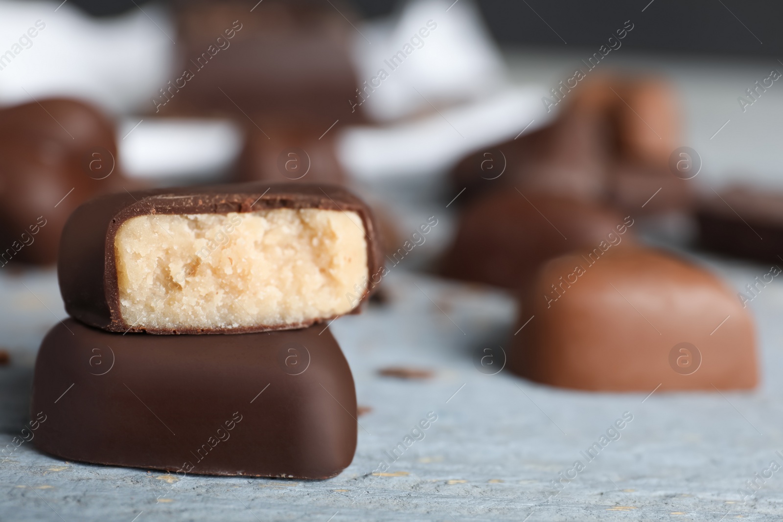 Photo of Beautiful heart shaped chocolate candies, closeup with space for text