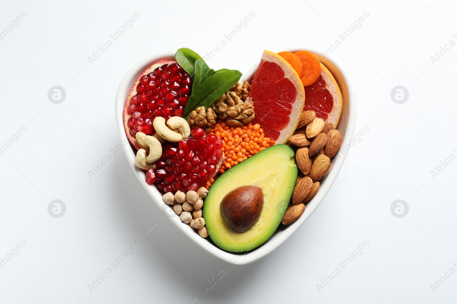 Photo of Bowl with products for heart-healthy diet on white background, top view