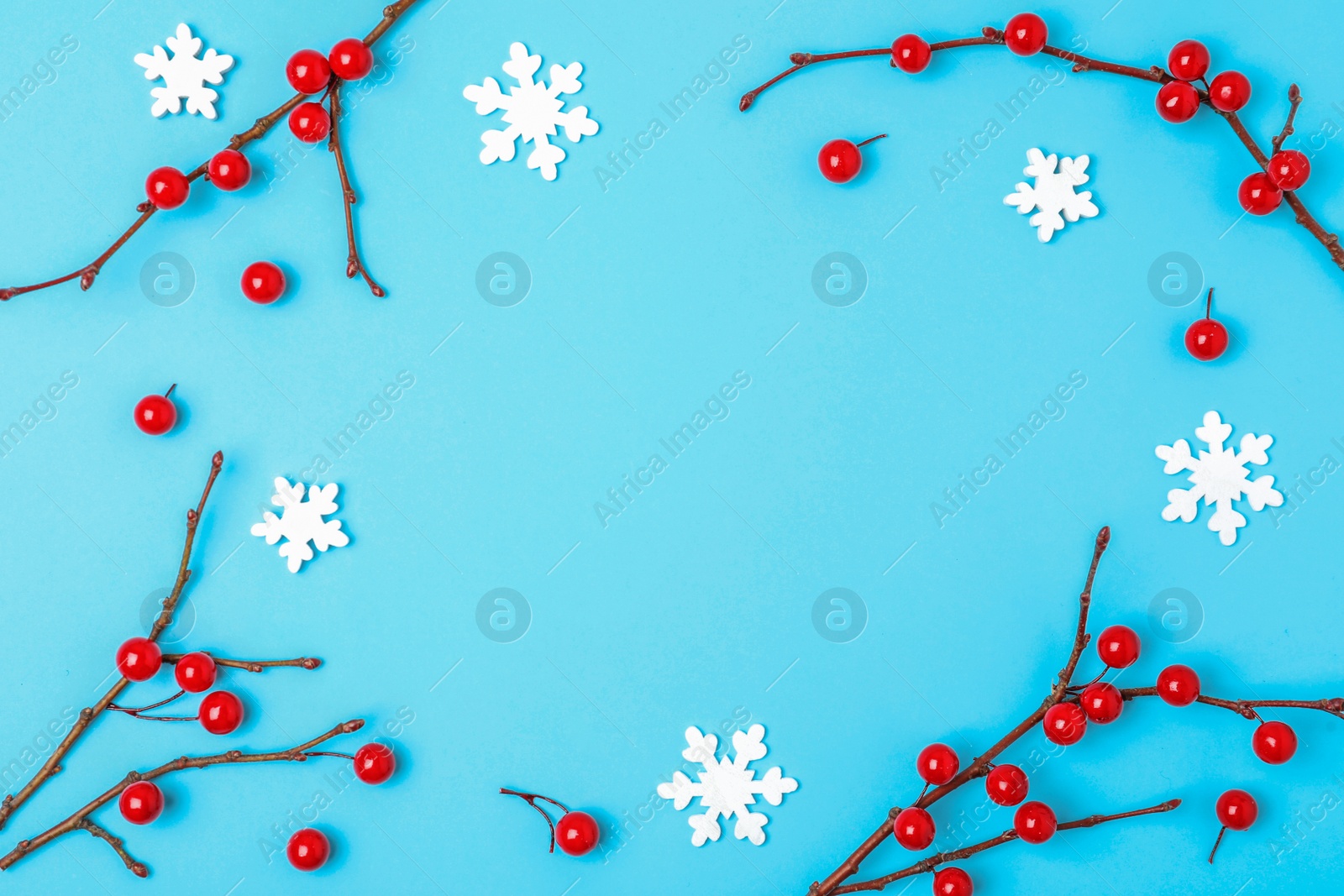 Photo of Winter composition with decorative branches on light blue background, flat lay. Space for text