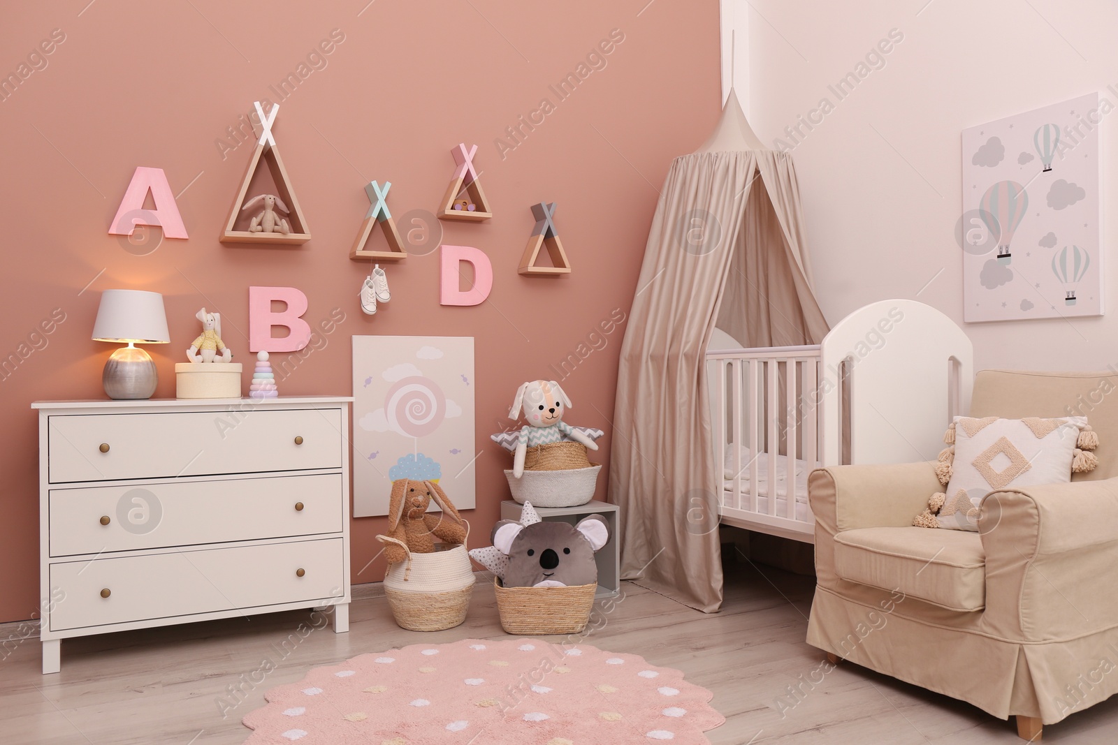 Photo of Baby room interior with stylish furniture and comfortable crib