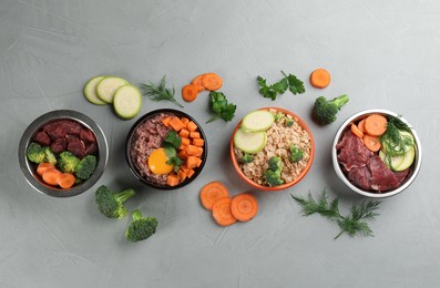 Photo of Pet food and natural ingredients on grey table, flat lay