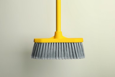 Plastic broom on light background. Cleaning tool