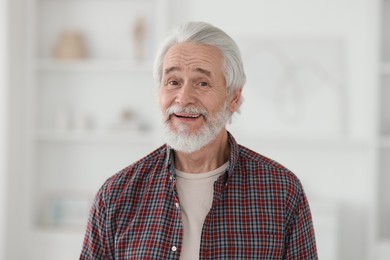 Portrait of happy grandpa with grey hair indoors