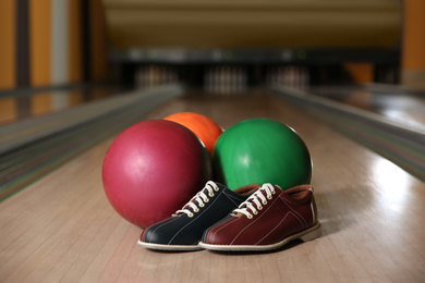 Photo of Shoes and balls on bowling lane in club