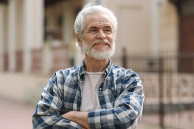 Photo of Portrait of happy grandpa with grey hair outdoors