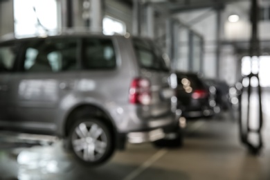 Photo of Blurred view of modern automobile repair shop