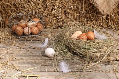 Fresh chicken eggs and dried straw bale in henhouse