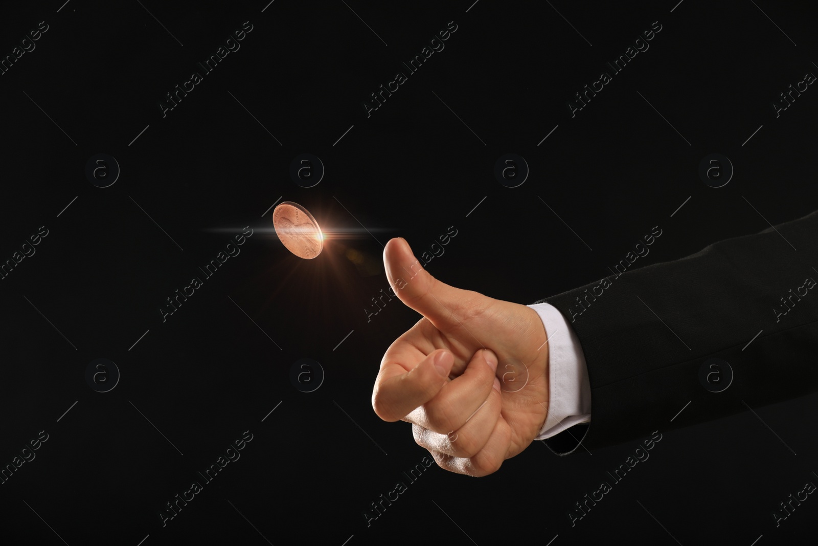 Image of Man throwing coin on black background, closeup. Making decision