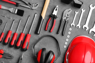 Photo of Flat lay composition with different construction tools on grey background