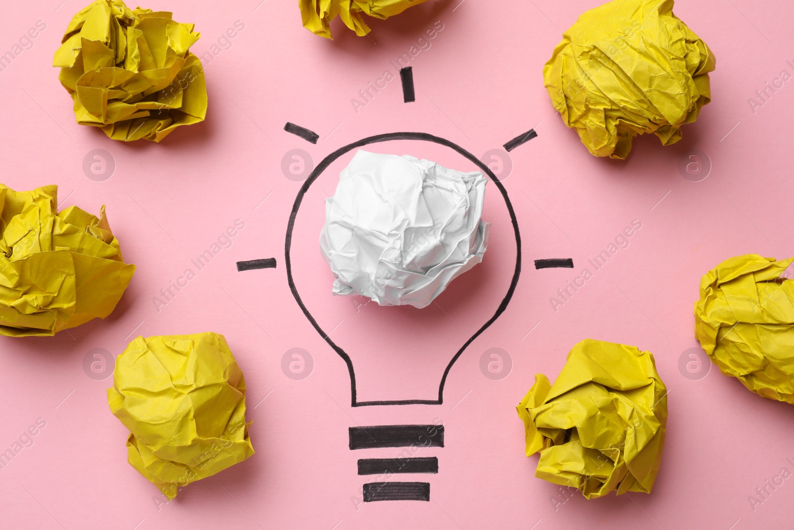 Photo of Idea concept. Light bulb made with crumpled paper and drawing on pink background, flat lay