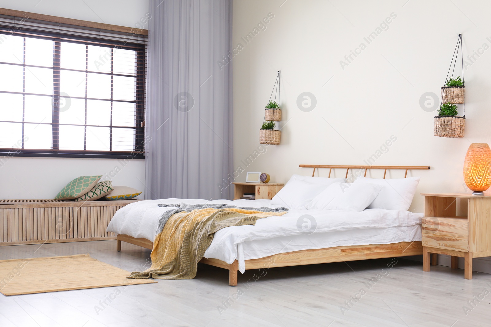 Photo of Modern room interior with comfortable double bed and window blinds