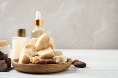 Photo of Organic cocoa butter on white wooden table