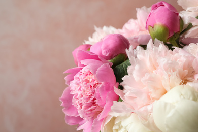 Beautiful peony bouquet on pink background, closeup