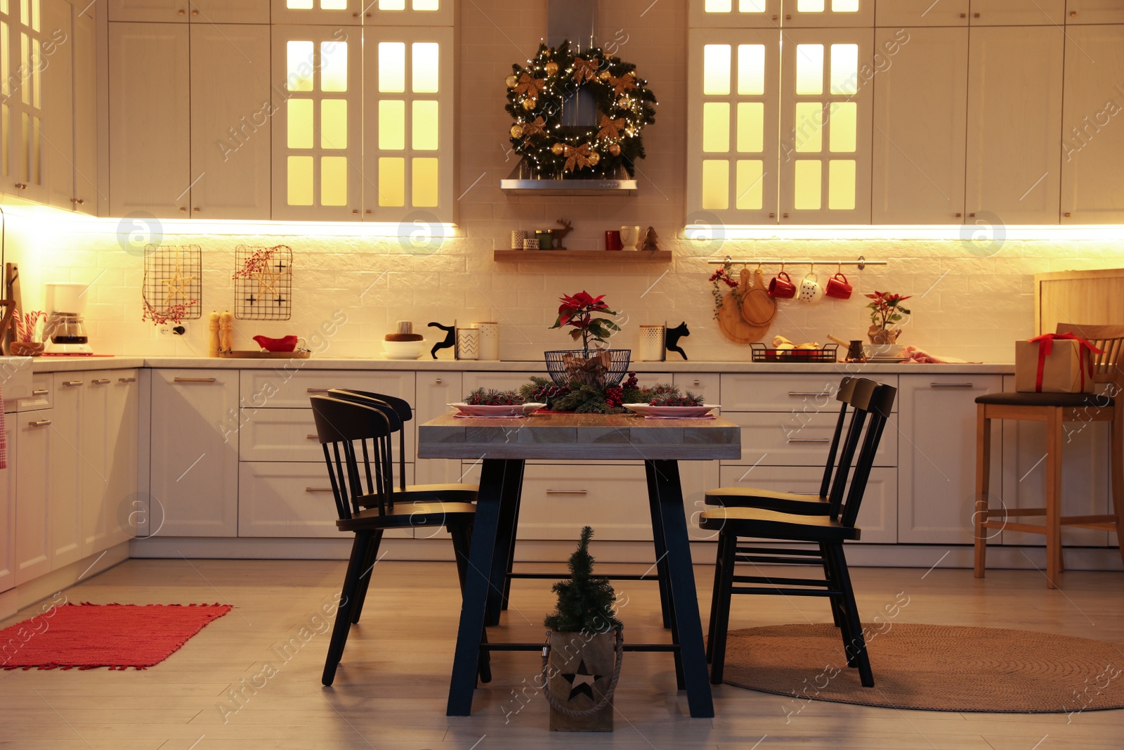 Photo of Cozy dining room interior with beautiful Christmas wreath and festive decor