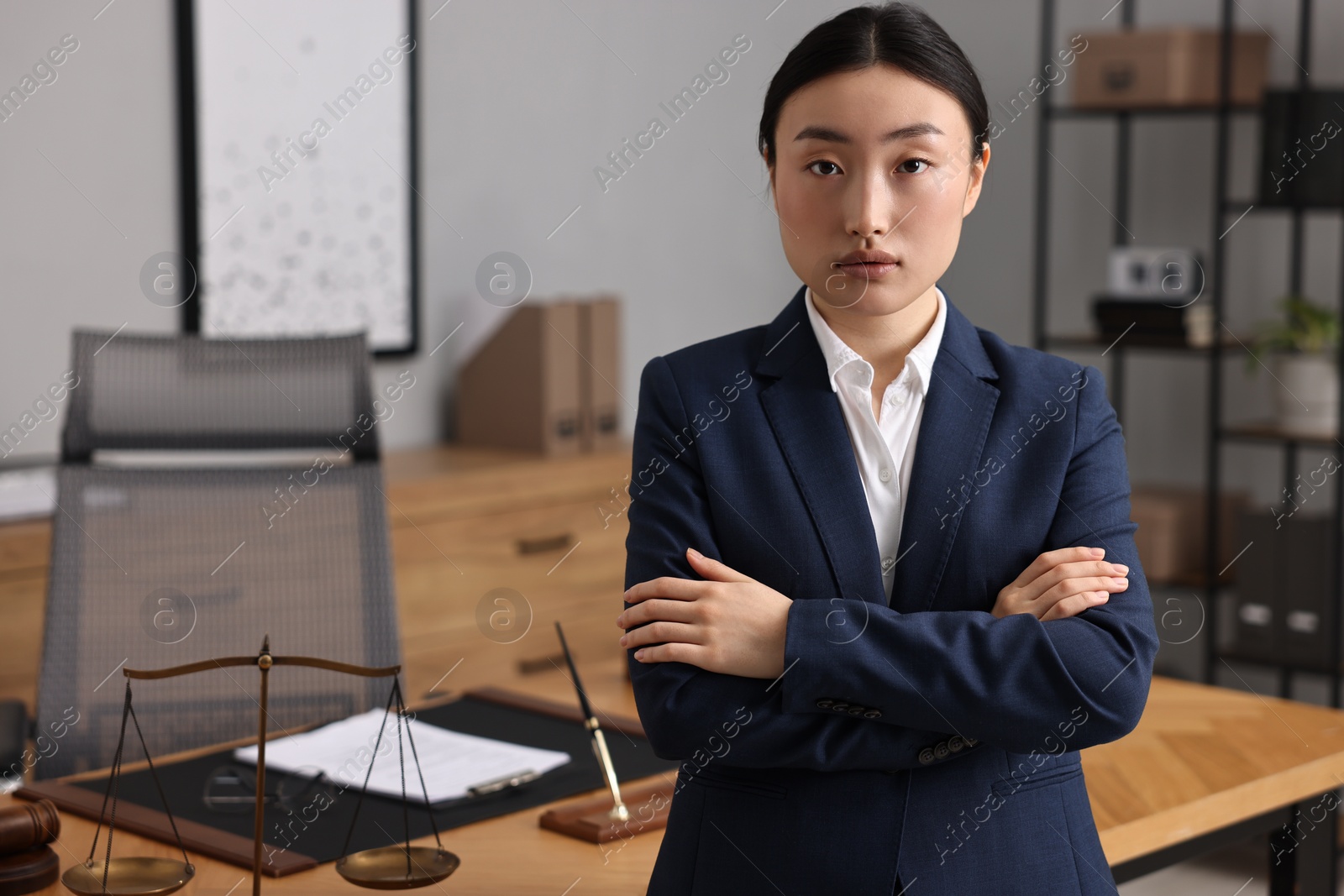 Photo of Portrait of notary with crossed arms in office. Space for text