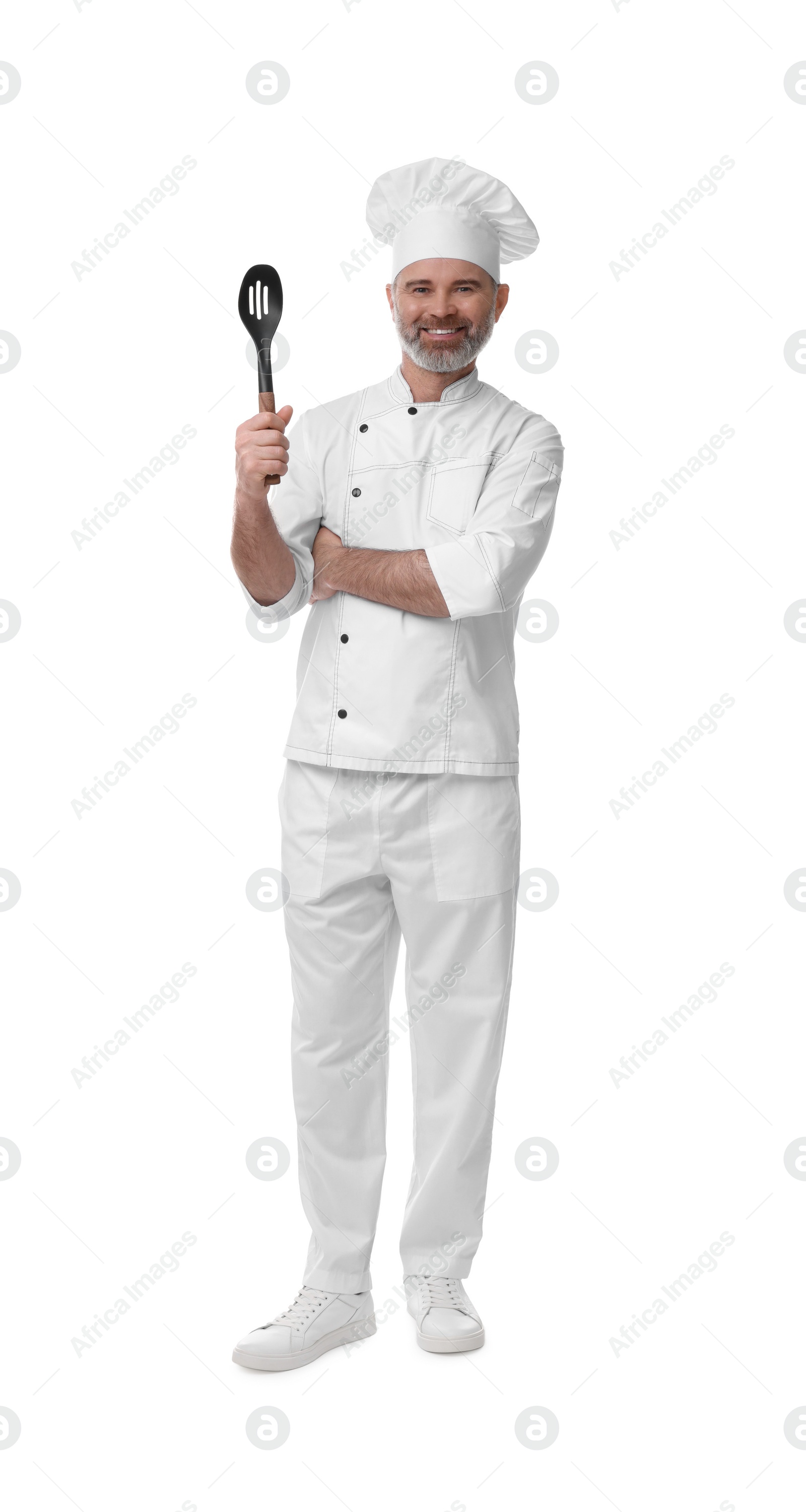 Photo of Happy chef in uniform with spoon isolated on white