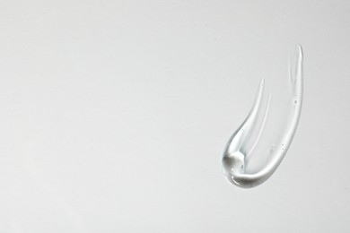 Photo of Sample of cosmetic gel on white background, top view. Space for text