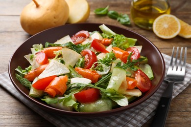 Photo of Delicious turnip salad served on wooden table, closeup