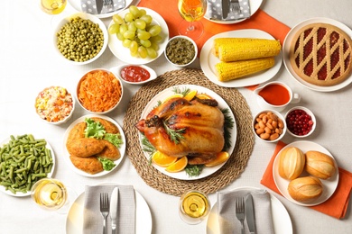 Photo of Delicious festive dinner with roasted turkey on table, flat lay