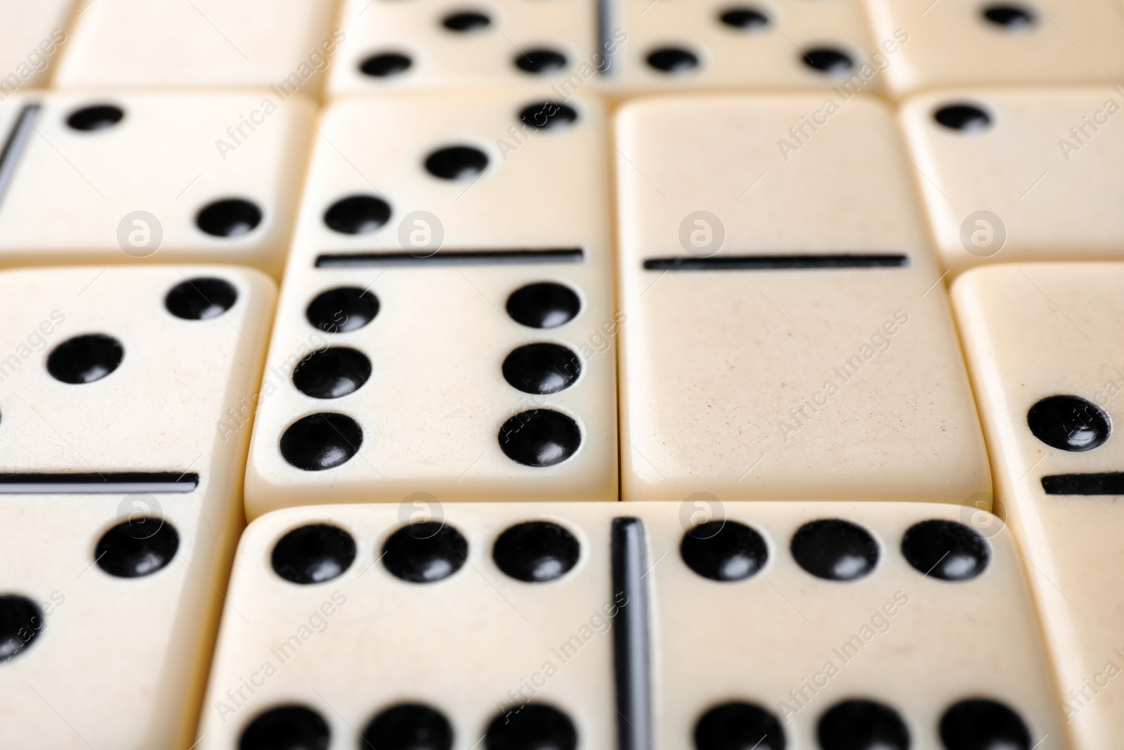 Photo of Set of classic domino tiles as background, closeup