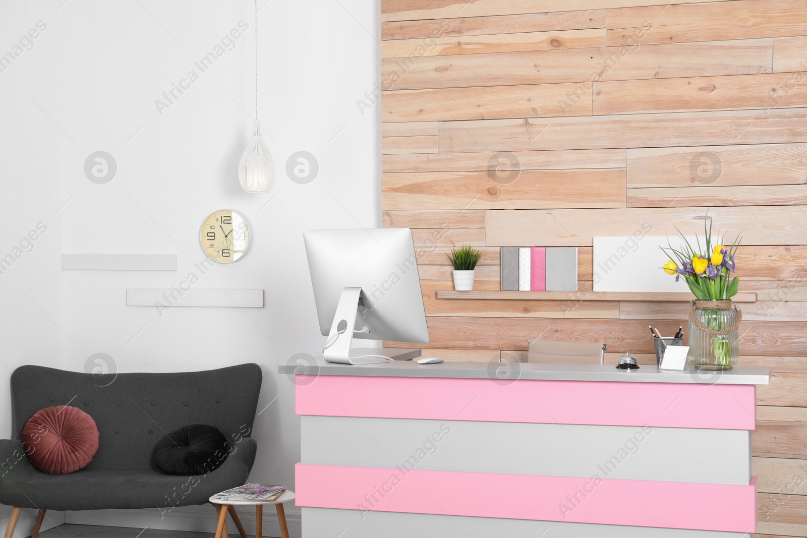 Photo of Stylish interior of beauty salon with modern reception desk near wooden wall