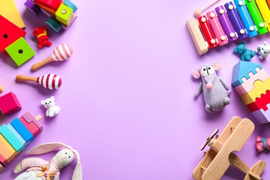 Photo of Different toys on lilac background, flat lay. Space for text