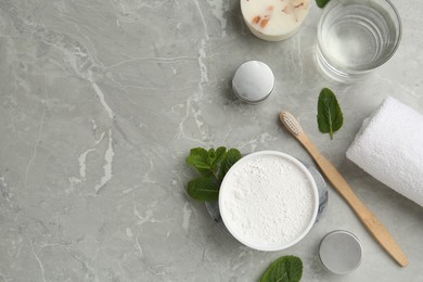 Photo of Flat lay composition with tooth powder and mint on light grey marble table, space for text