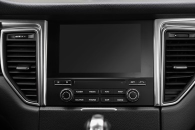 Photo of Modern navigation system with screen in car, closeup