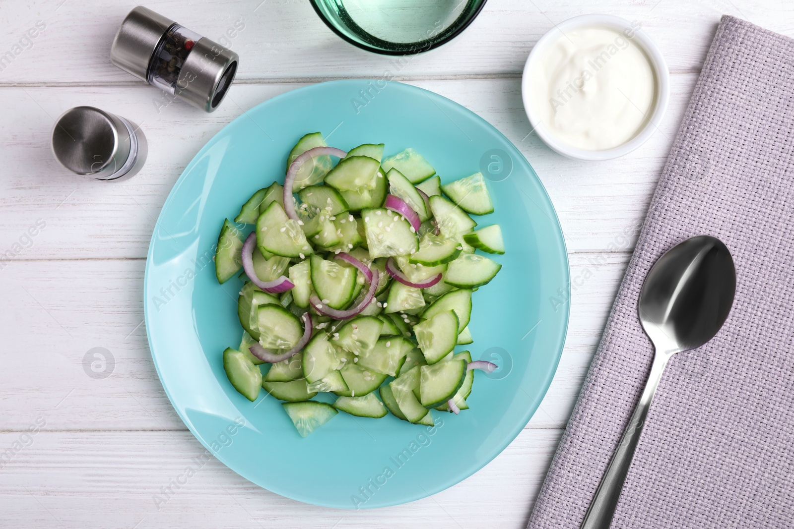 Photo of Flat lay composition with delicious fresh cucumber onion salad on table