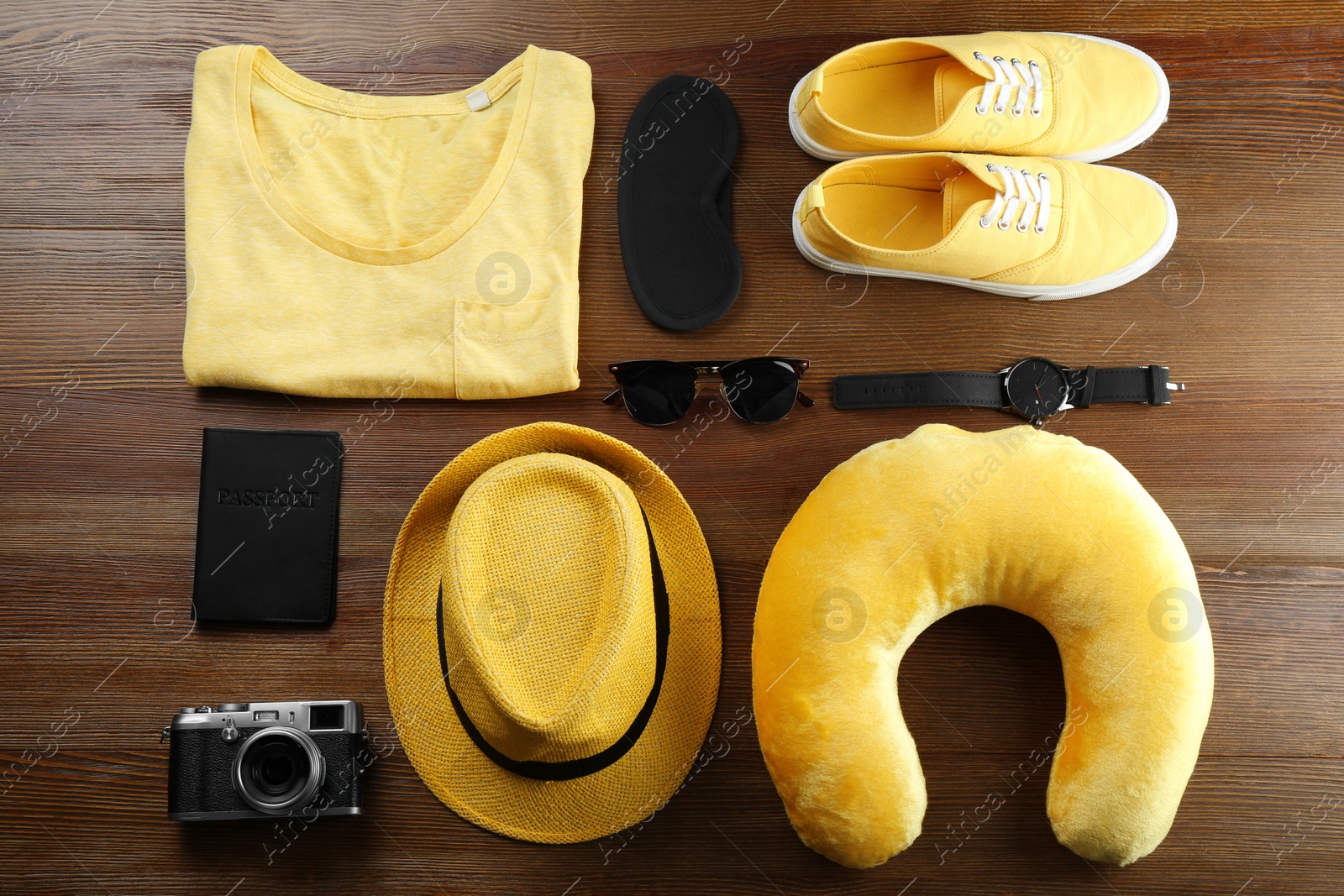 Photo of Flat lay composition with travel pillow and tourist stuff on wooden background