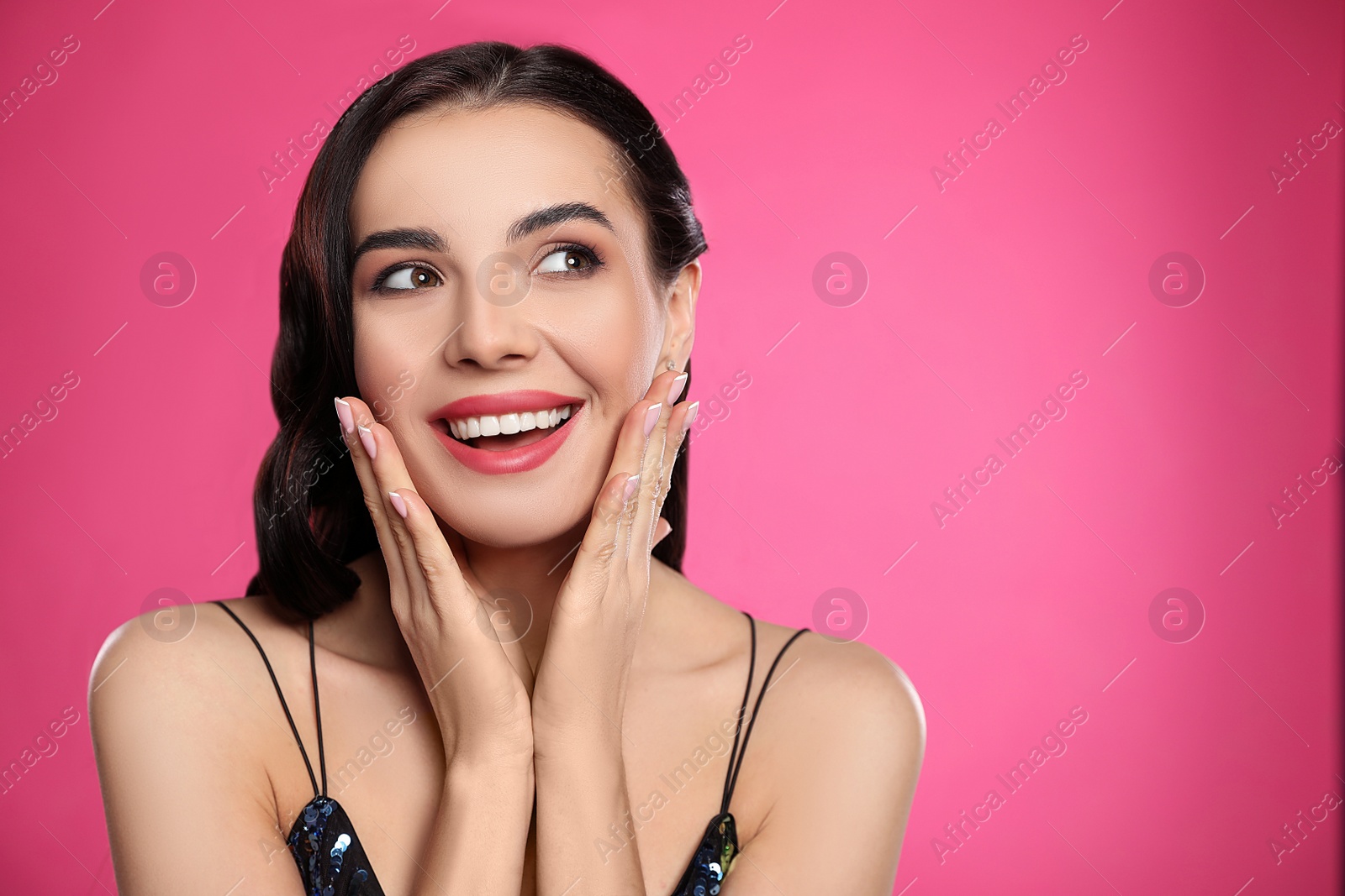 Photo of Portrait of surprised woman on pink background, space for text