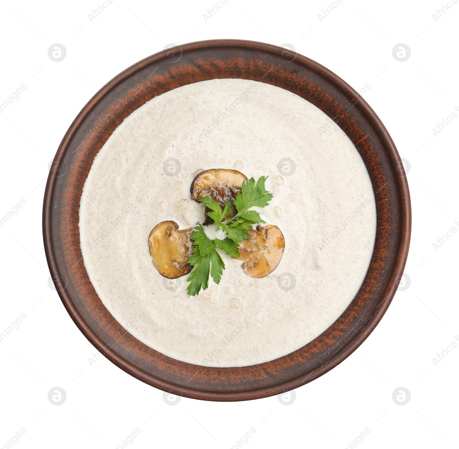 Photo of Fresh homemade mushroom soup in ceramic bowl isolated on white, top view