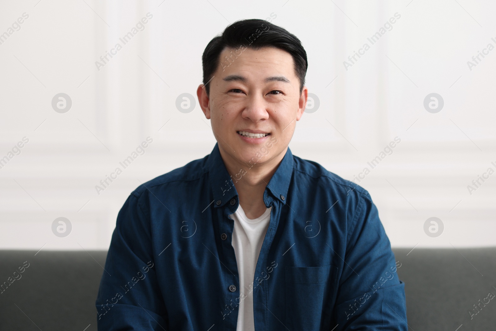 Photo of Portrait of smiling friendly businessman in office