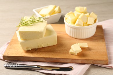 Photo of Tasty butter with dill and knife on wooden table