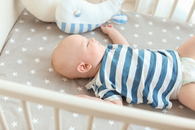 Cute little baby lying in crib. Sleeping time