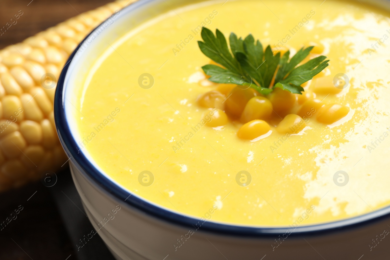 Photo of Delicious creamy corn soup in bowl, closeup