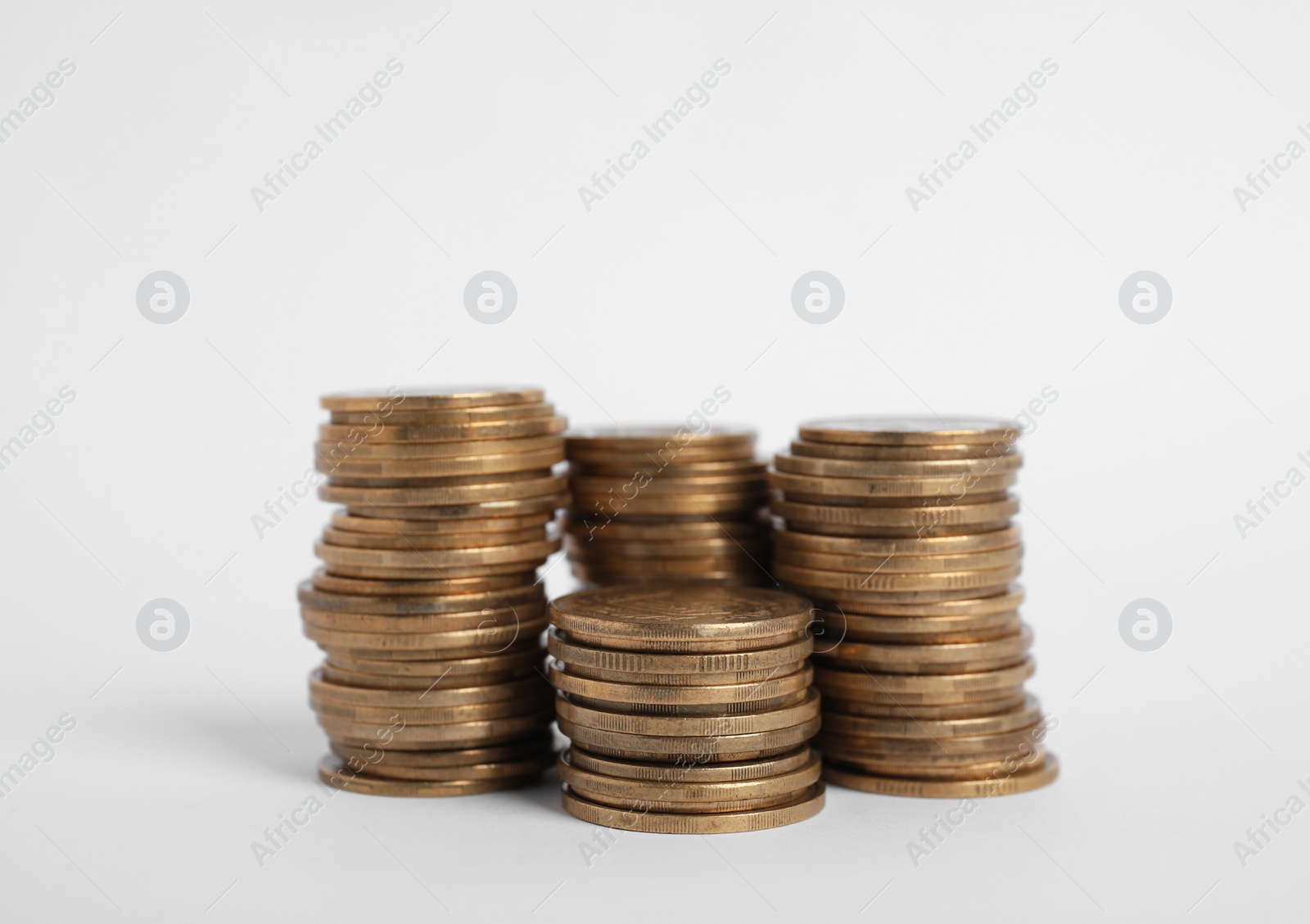 Photo of Many Euro coins stacked on white background