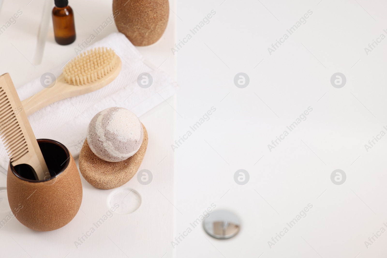 Photo of Different personal care products and accessories on bath tub, above view. Space for text