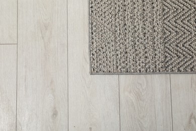 Soft grey carpet on white laminated floor indoors, top view. Space for text