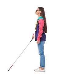 Young blind person with long cane walking on white background