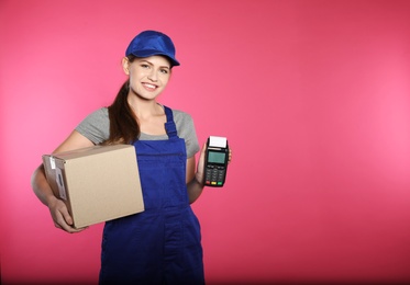 Photo of Smiling courier with payment terminal and parcel on color background. Space for text