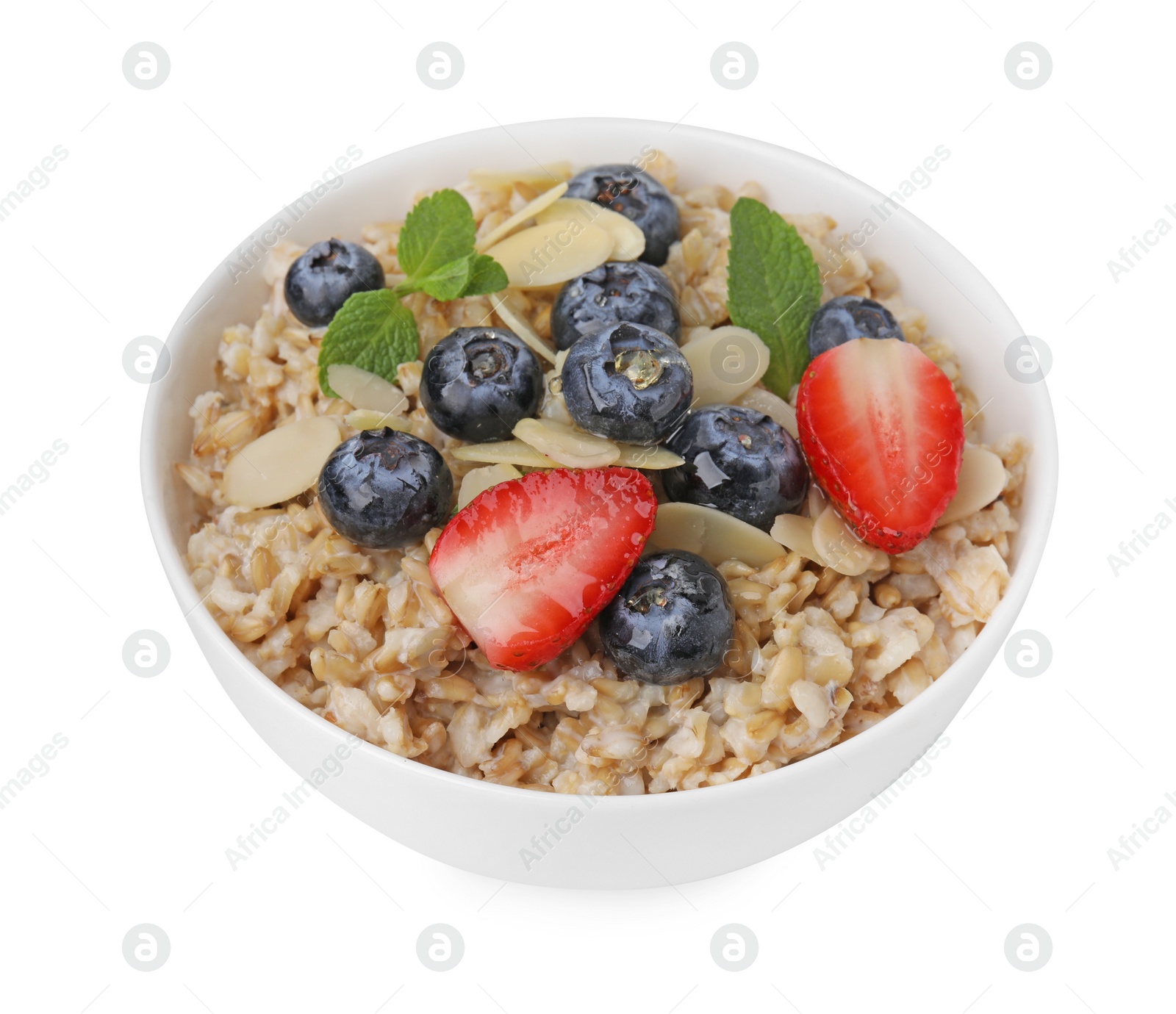 Photo of Tasty oatmeal with strawberries, blueberries and almond flakes in bowl isolated on white