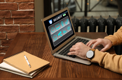 Image of Man using home security app indoors, closeup