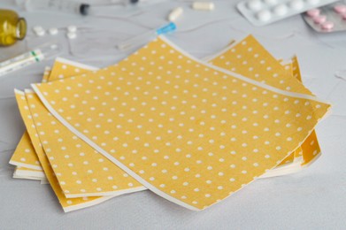 Photo of Yellow mustard plaster on light gray table, closeup