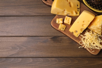Photo of Tasty fresh cheese on wooden table, top view. Space for text