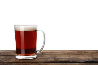 Glass mug of delicious kvass on wooden table, white background