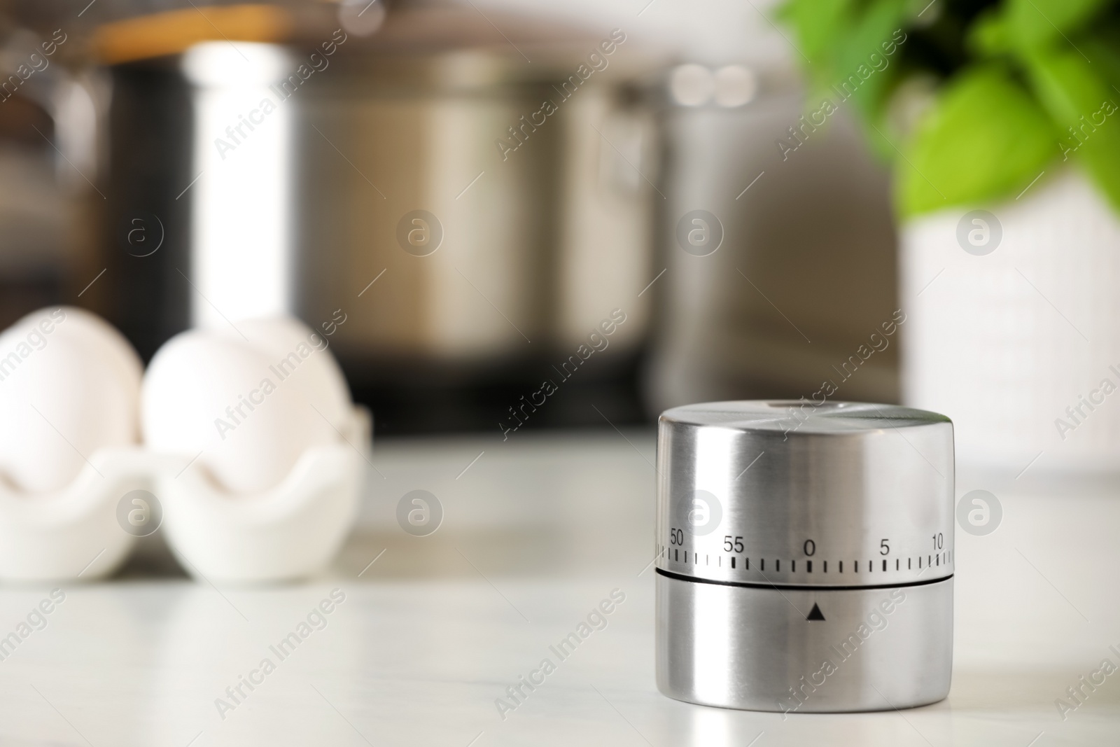 Photo of Kitchen timer on white table indoors. Space for text